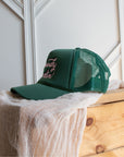 Green western slogan trucker cap with bold pink Howdy Darlin' embroidery