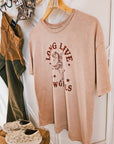Close-up of the screen-printed cowgirl graphic on a pink vintage mineral wash t-shirt
