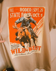 Close-up of the vintage-inspired rodeo cowboy graphic on the Wild West tee