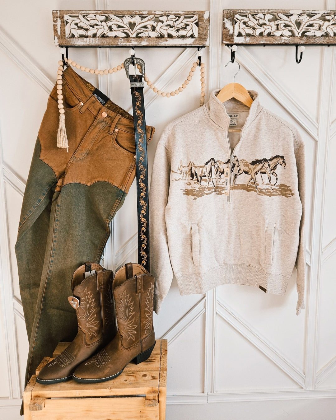 Black floral tooled leather belt styled with an Ariat horse print sweatshirt