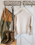 Back view of the Ariat Running Wild half-zip sweatshirt styled in a Western outfit