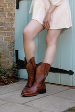 The rich brown leather colour and elegant stitching of these western boots