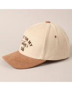 cream and tan western slogan cap