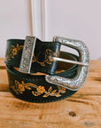 Black floral tooled leather belt with hand-painted flowers and a silver Western buckle