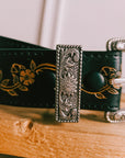 Full length view of the black floral tooled leather belt by Axesoria West