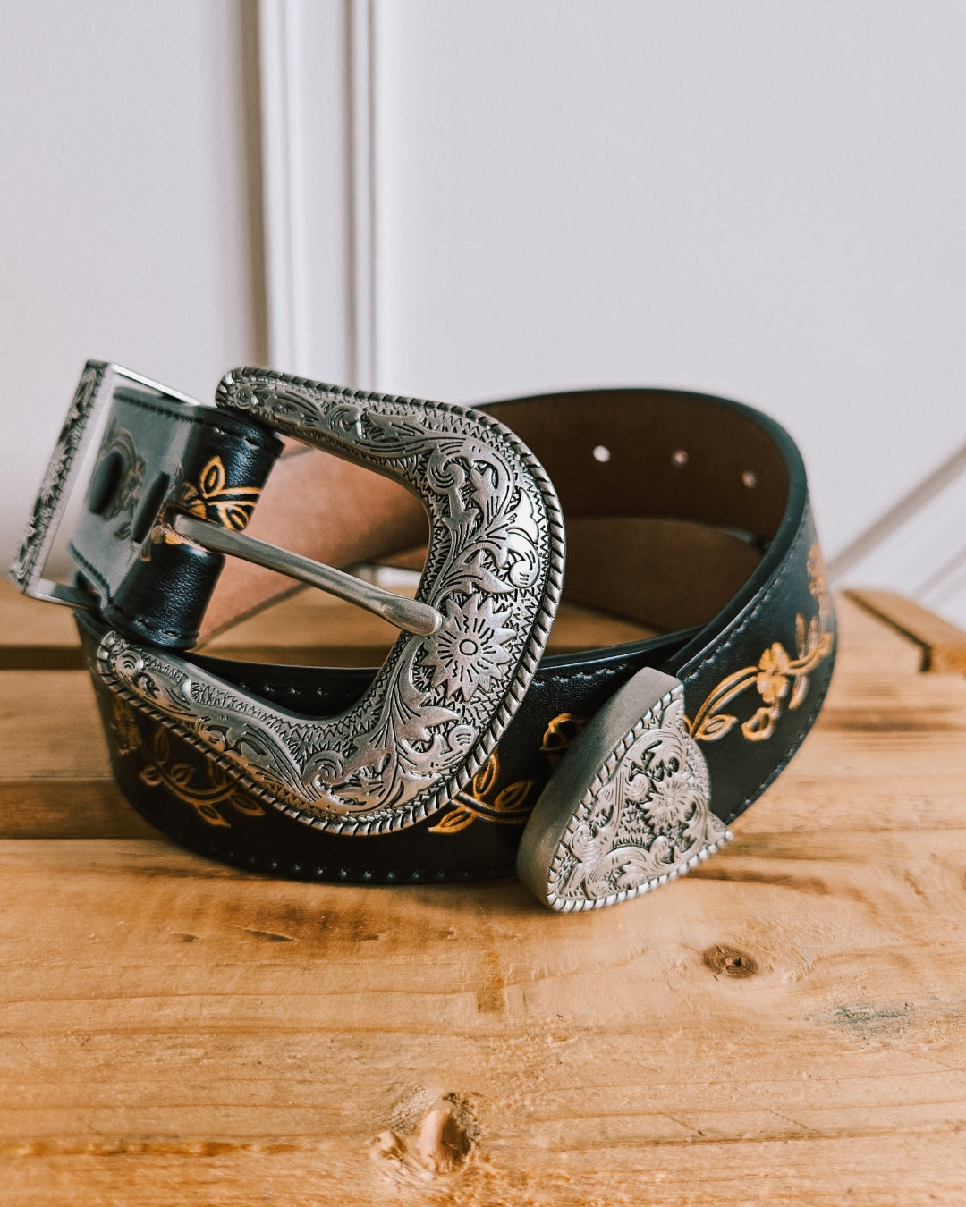 Black floral tooled leather Western belt with 3-piece silver buckle set