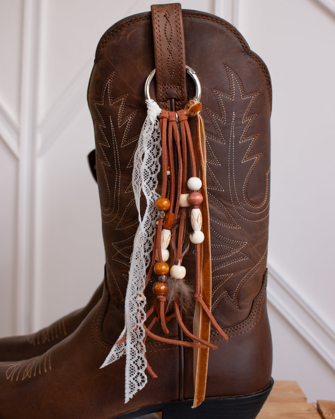 Brown and lace cowboy boot tassel accessory detail
