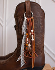 Brown and lace cowboy boot tassel accessory detail