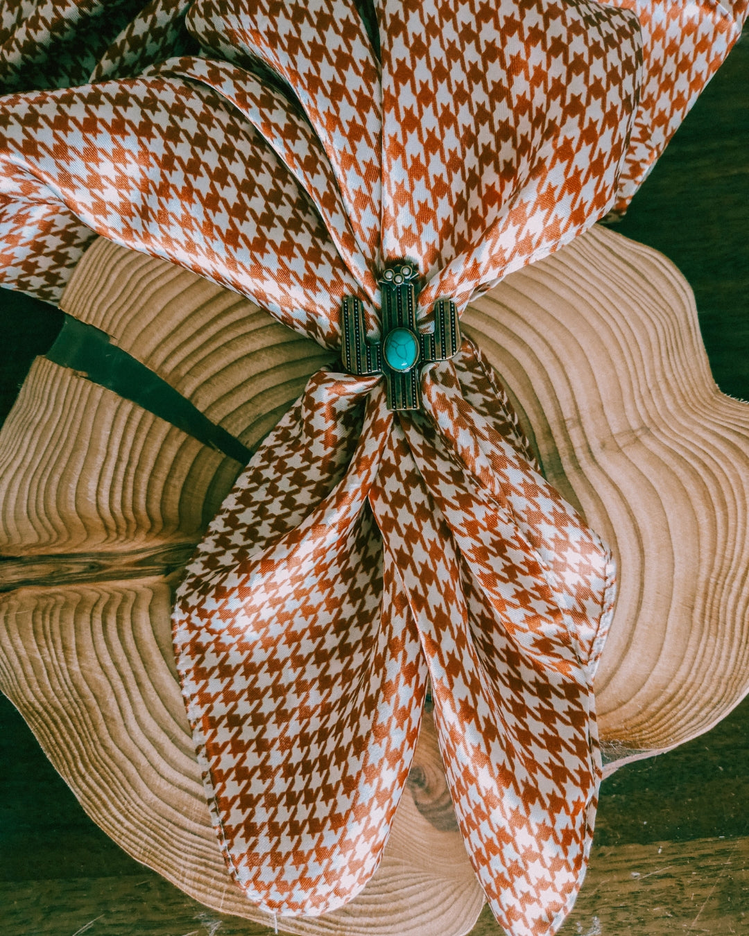 Brown and White Houndstooth Wild Rag styled with a cactus scarf slide