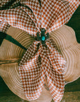Brown and White Houndstooth Wild Rag styled with a cactus scarf slide