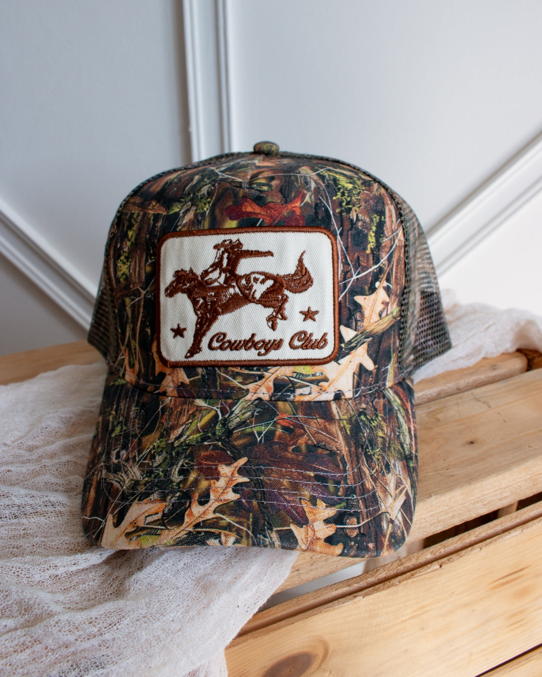 Camo Cowboys Club trucker cap with premium embroidered western patch