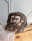 Camouflage western trucker cap with embroidered cowboy patch detail