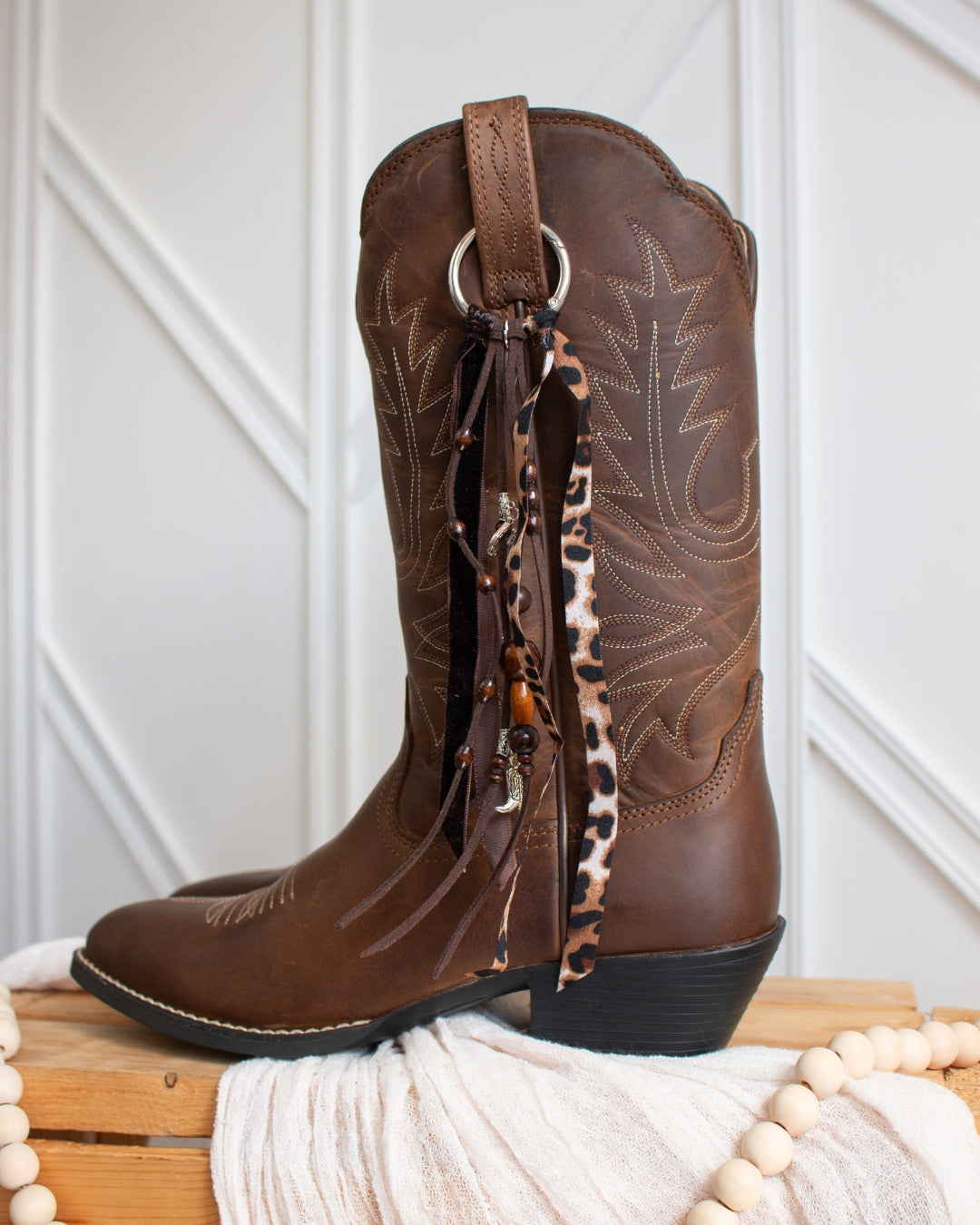 Leopard cowboy boot tassel styled on Ariat boots, side view