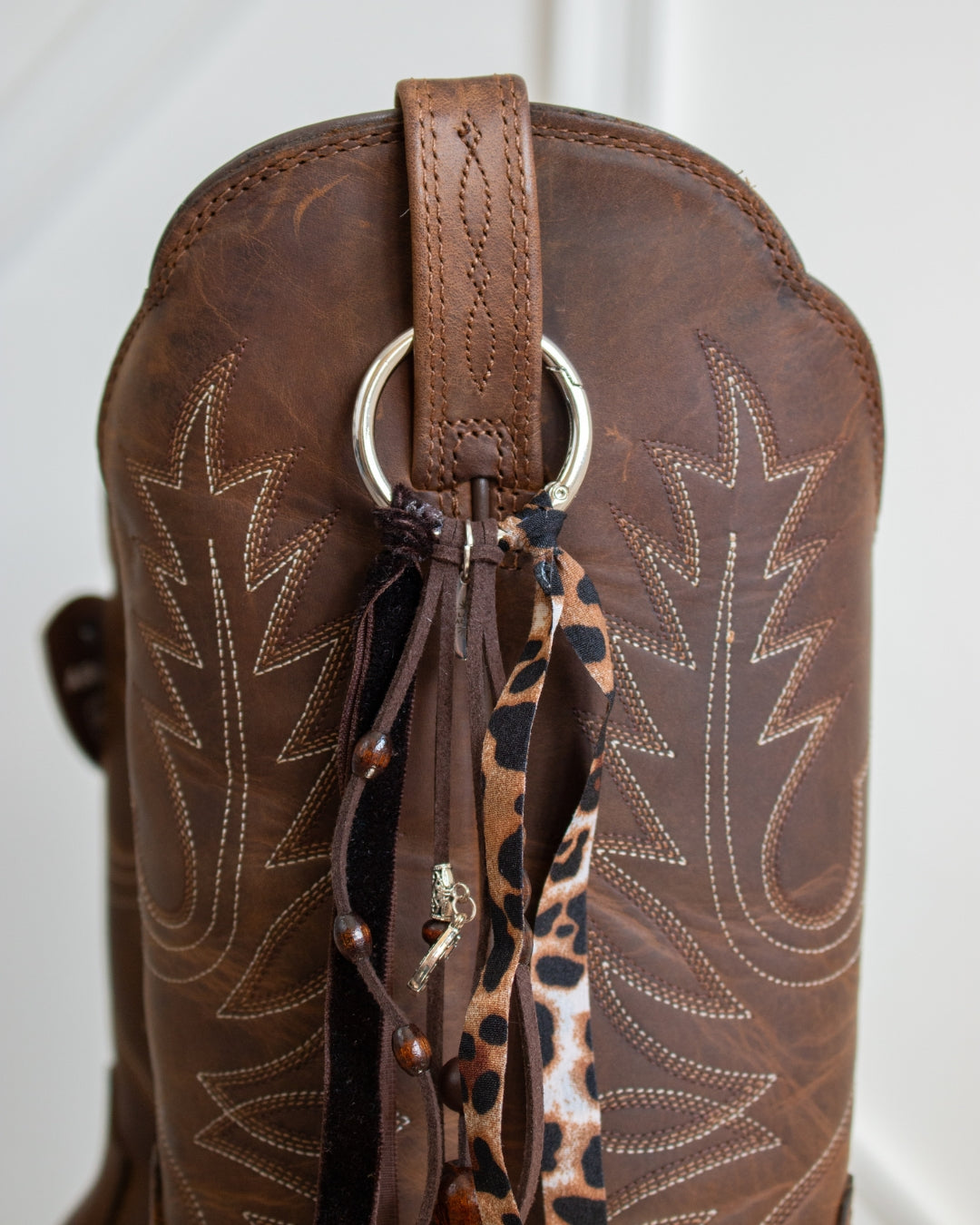 Leopard print velvet cowboy boot tassel, zoomed detail
