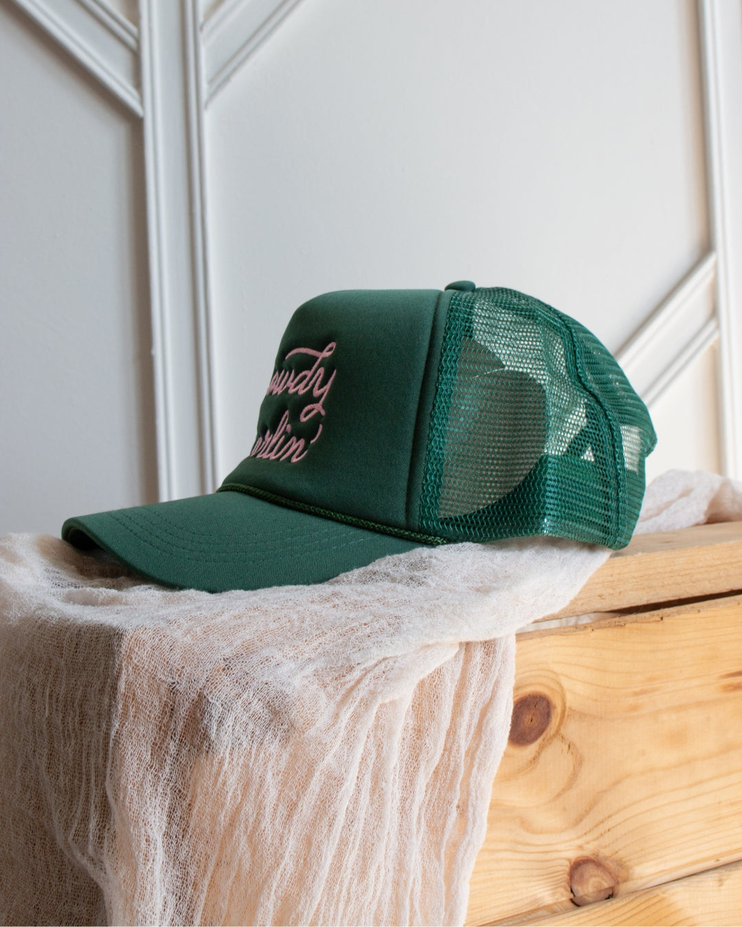 Green western slogan trucker cap with bold pink Howdy Darlin' embroidery
