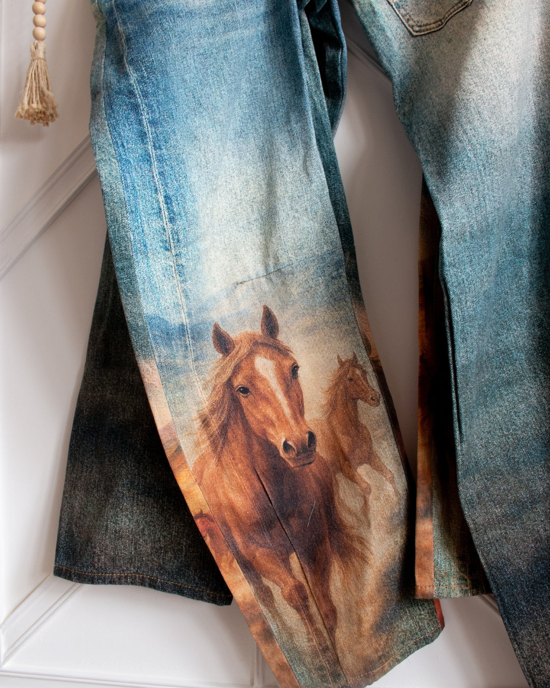 Western horse print barrel jeans showing statement graphic and barrel leg fit