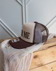 Brown western slogan trucker cap with bold Beer Me graphic
