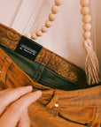 Close-up of the embroidery detail on Wrangler x Lainey Wilson brown chap jeans